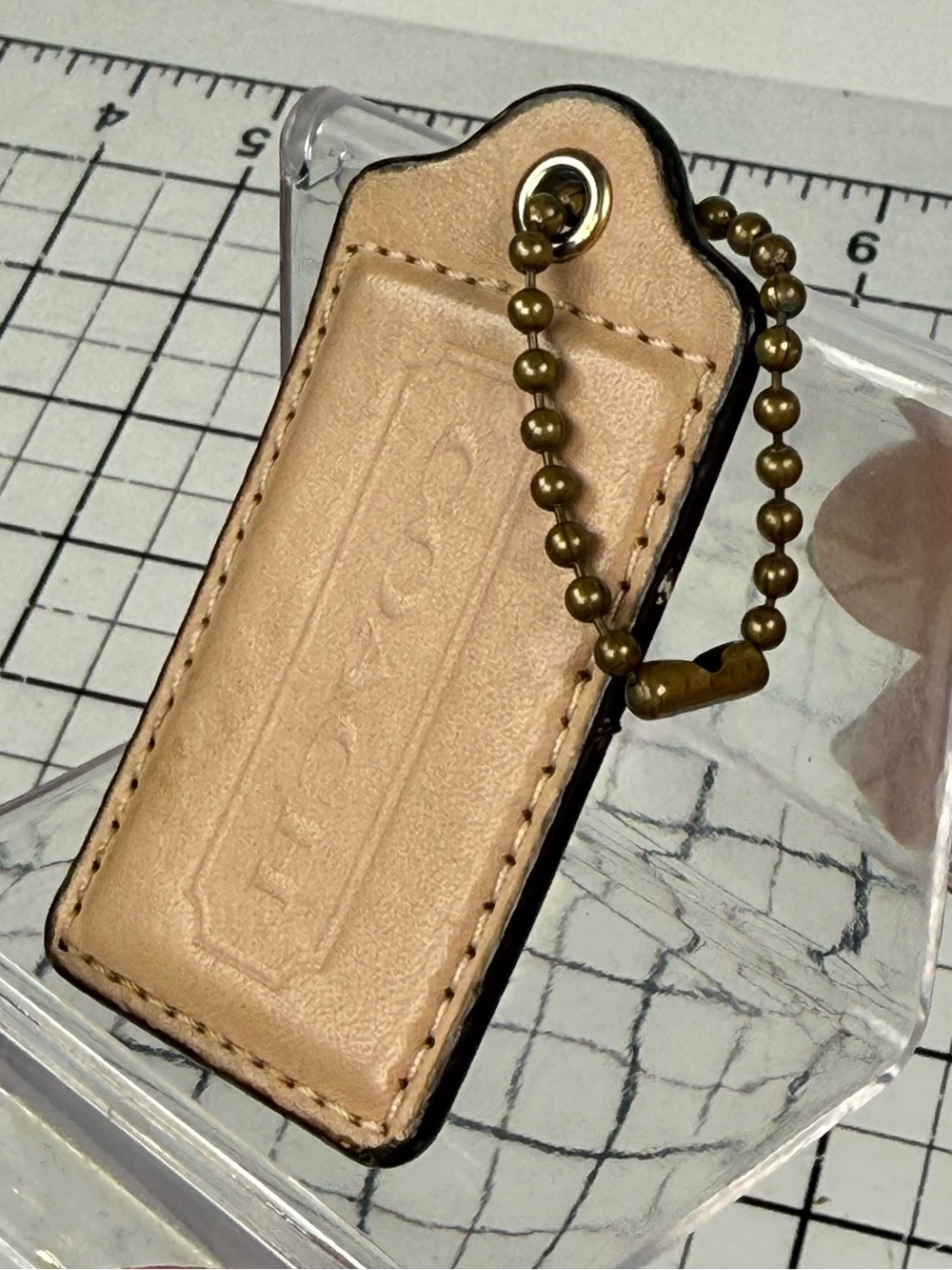 Coach Embossed Leather Key hang Tag - Nude/Tan with chain. 3 by 1.5 inches.